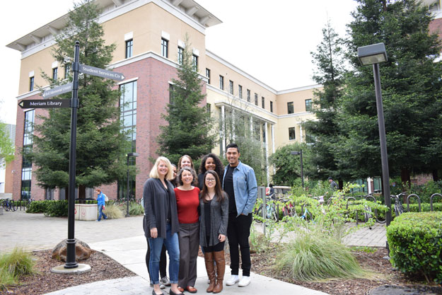First generation group stands outside the Student Services Center 