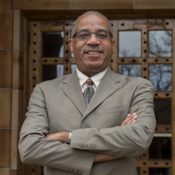 Dr. Pedro Douglas stands in front of Kendall Hall.